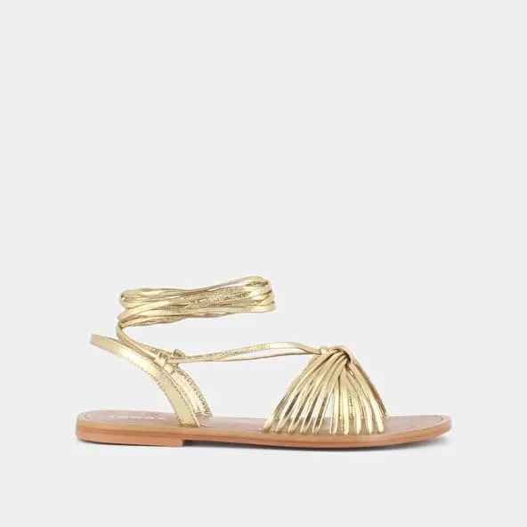 Sandals with ties in gold metallic leather